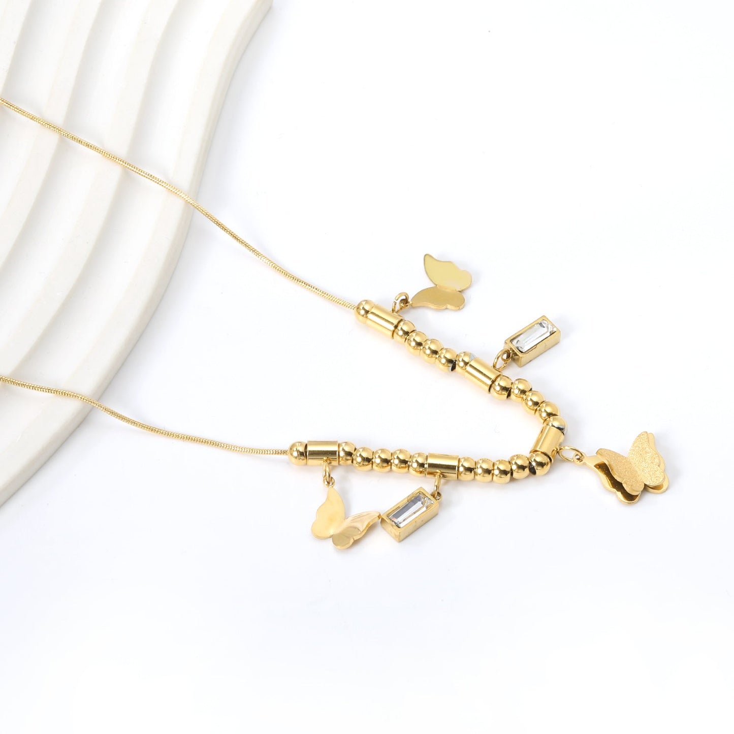 3 size butterflies 12*10mm+2 rectangular white diamond pendants 4.3*8.3mm+22 round through beads+5 round through posts Necklace 41+5cm Gold color
