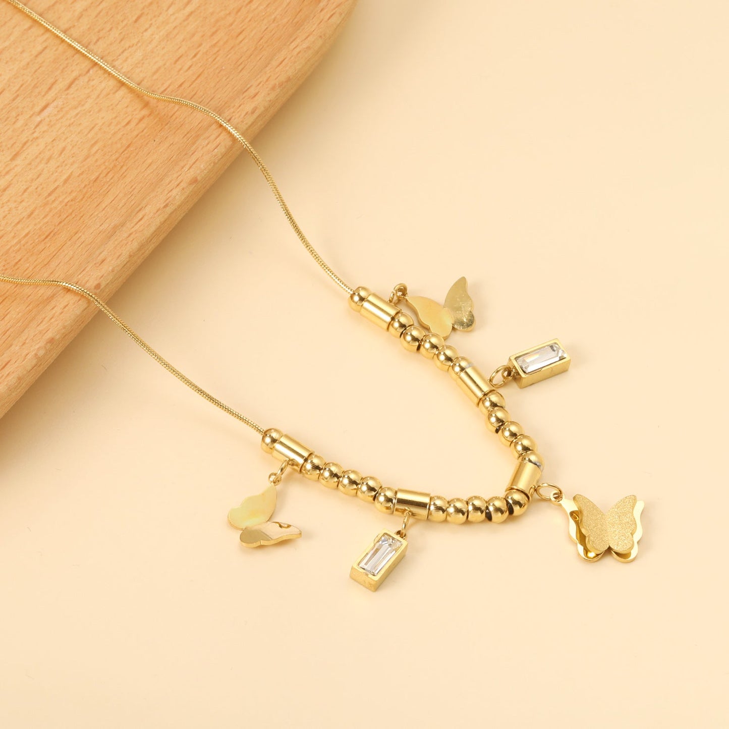 3 size butterflies 12*10mm+2 rectangular white diamond pendants 4.3*8.3mm+22 round through beads+5 round through posts Necklace 41+5cm Gold color