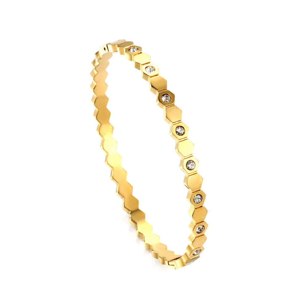 Hard bracelet with diamonds strung together with small gold-colored discs