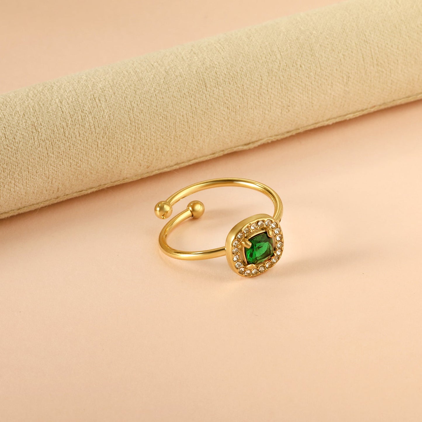 Square green diamond with small white diamonds ending in an open round bead ring