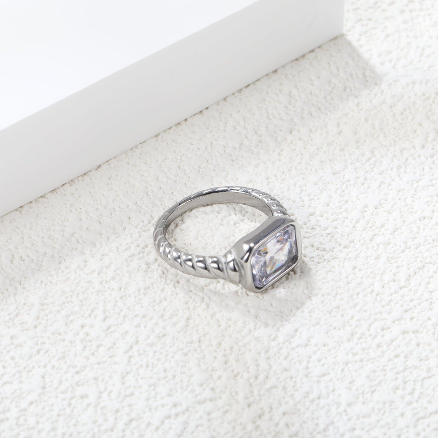 Oversized white diamonds on a threaded band ring.