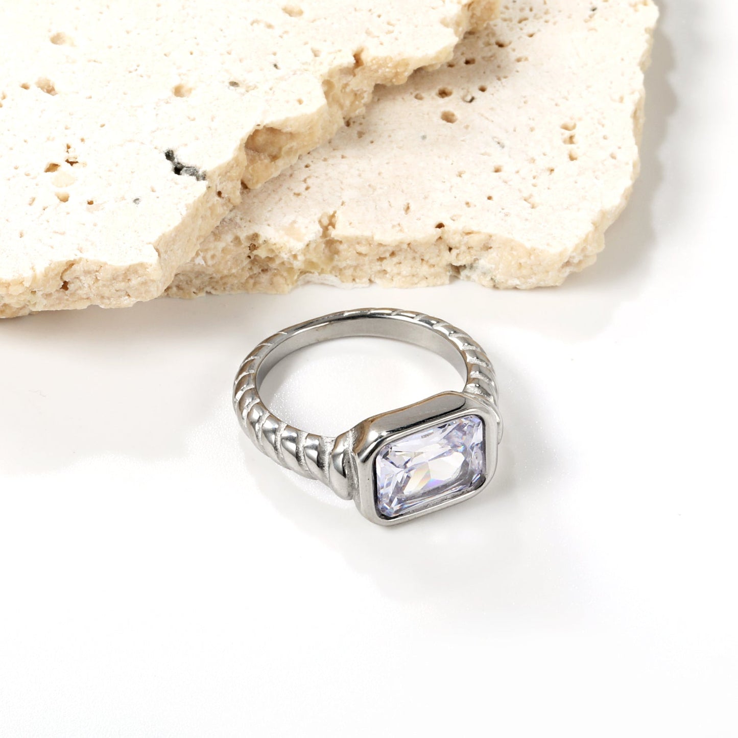 Oversized white diamonds on a threaded band ring.