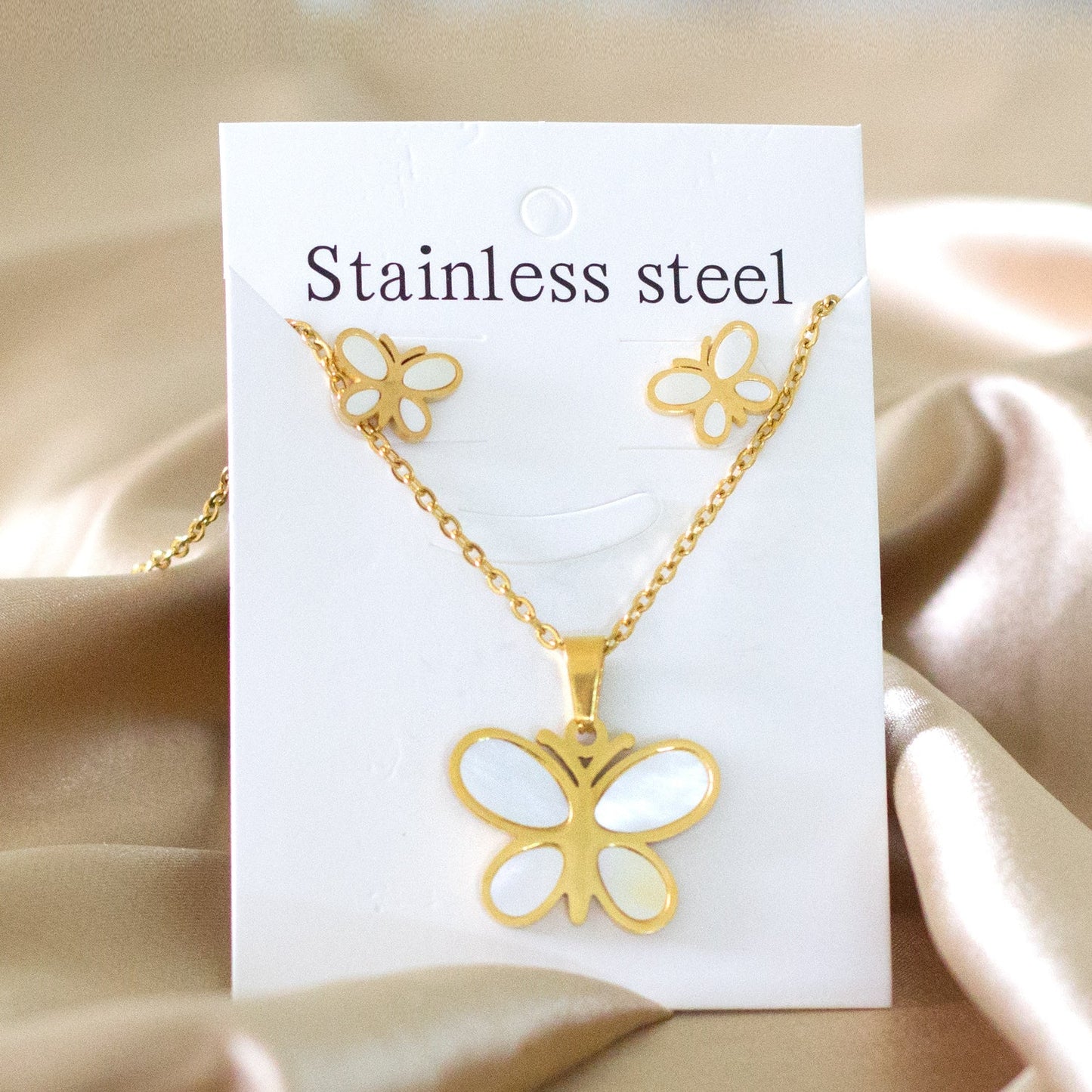 Steel/golden finish cut + butterfly shape with white shells adhered jewelry set