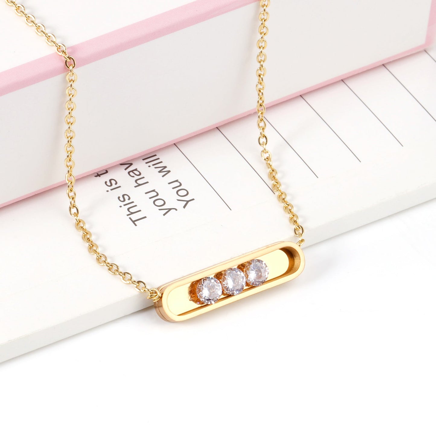 Golden hollow cylindrical center pendant necklace with white diamonds