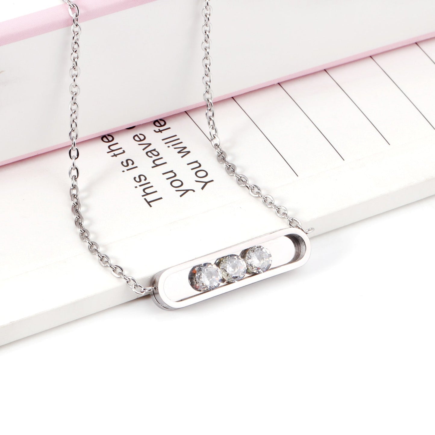 Golden hollow cylindrical center pendant necklace with white diamonds