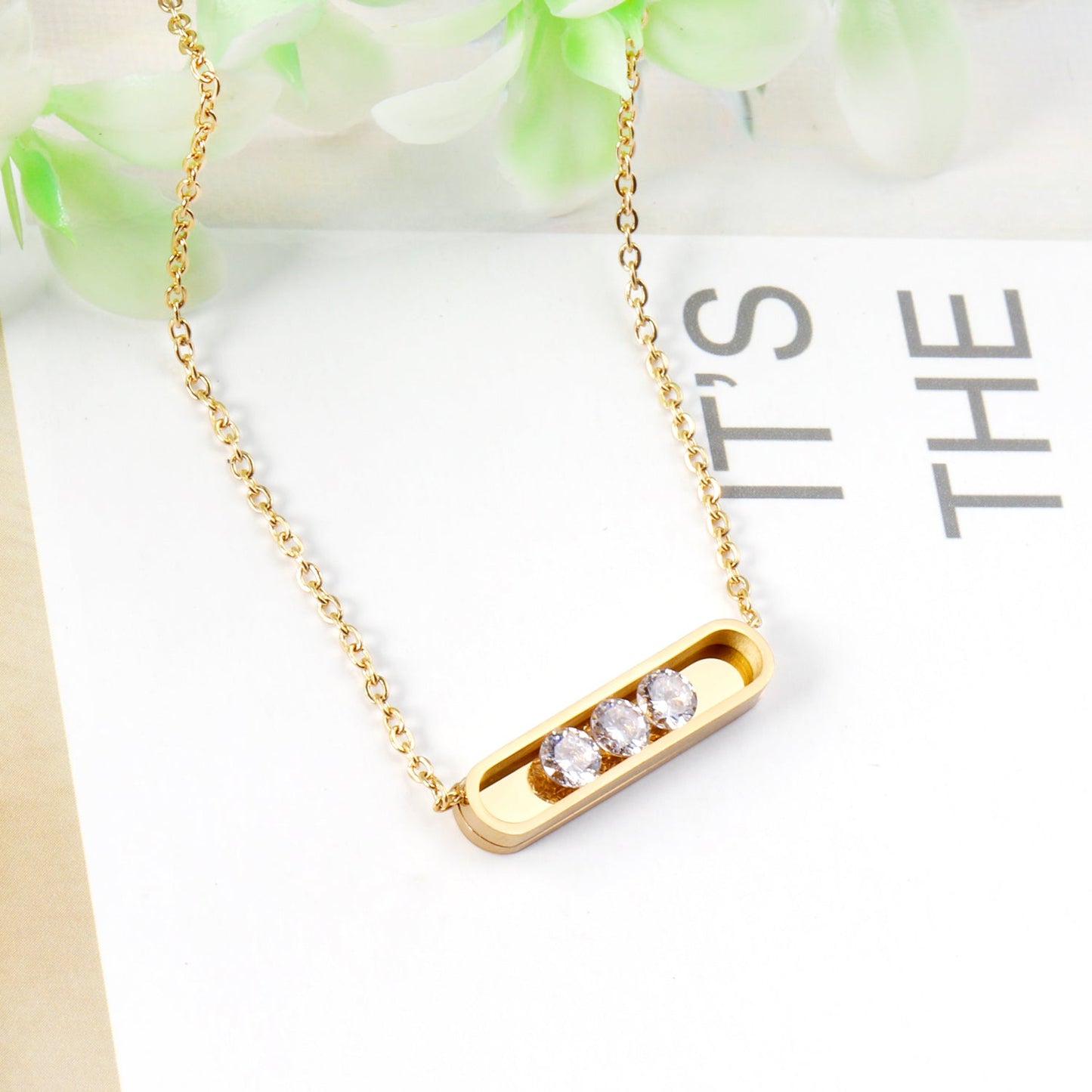 Golden hollow cylindrical center pendant necklace with white diamonds