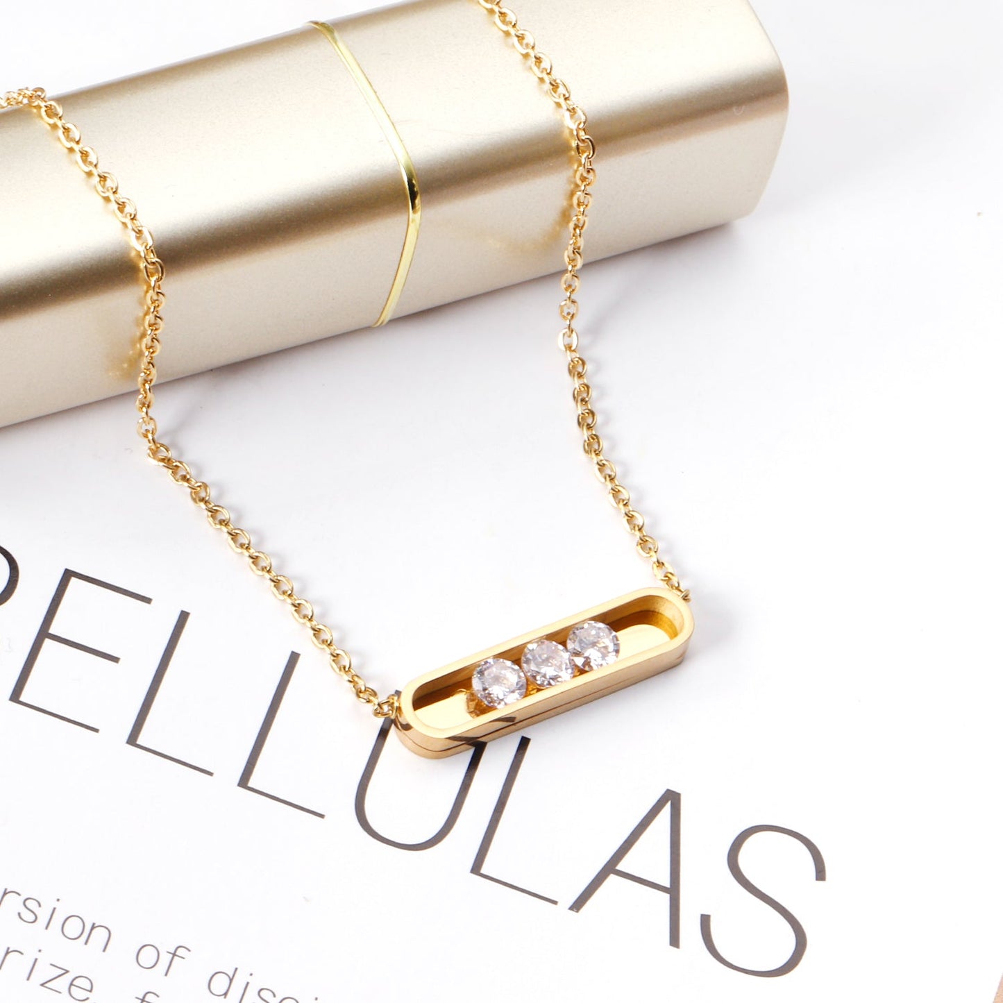 Golden hollow cylindrical center pendant necklace with white diamonds