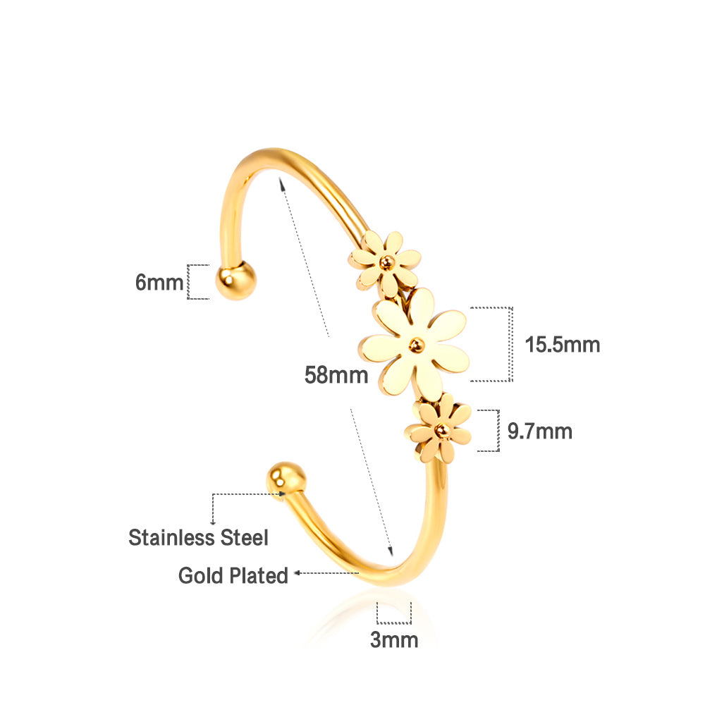 Gold colored hard bracelet with three small flowers of different sizes