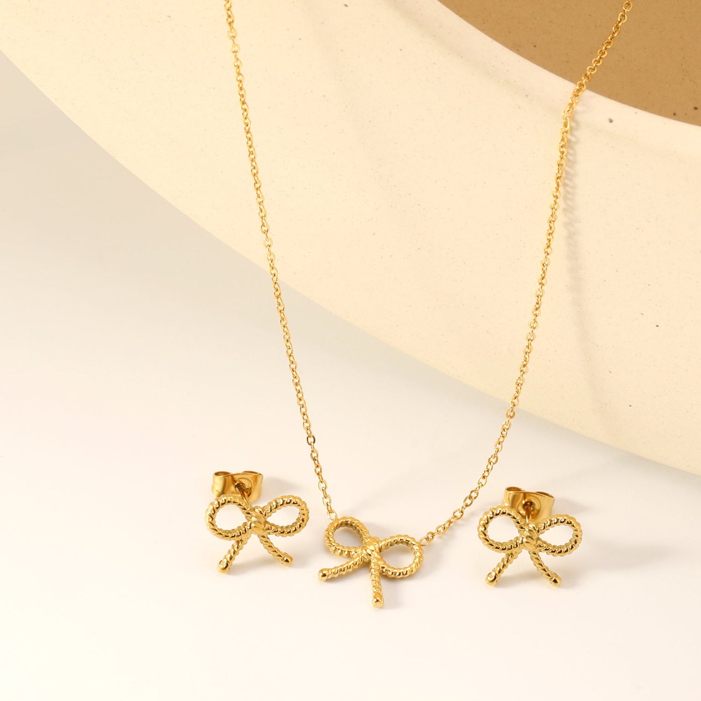 Bow Set Steel Color Earrings:13.2*11.2mm Necklace:13.2*11.2mm0.3 Cross Chain*40+5cm+6mm Round Plaque
