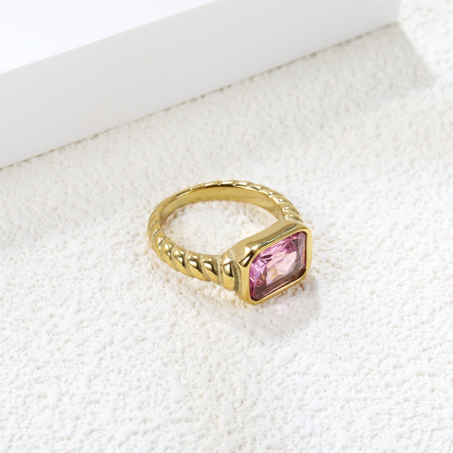 Oversized pink diamonds on a threaded band ring.