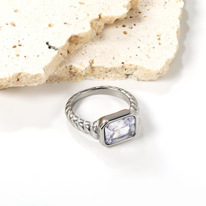 Oversized white diamonds on a threaded band ring.