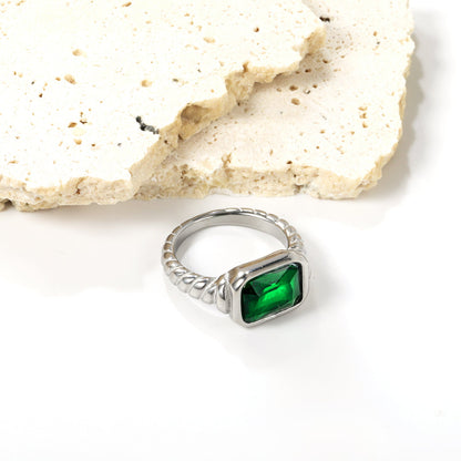 Oversized green diamonds on a threaded band ring.