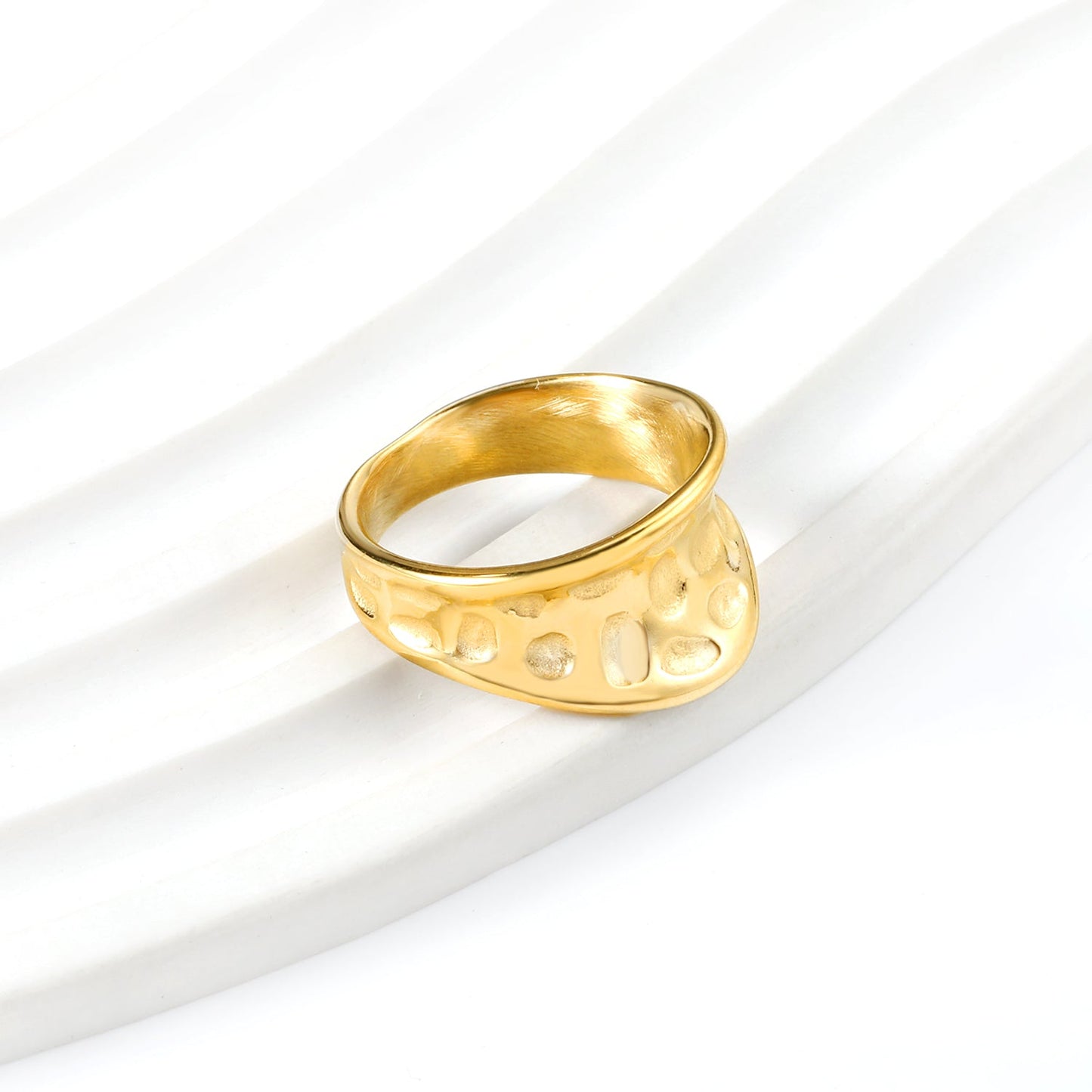 Exaggerated ring with cratered surface