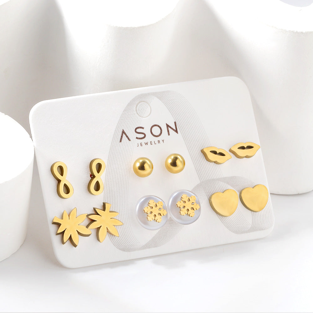 Six pairs of mixed card mounted cut glossy lips / maple leaf stud earrings gold color