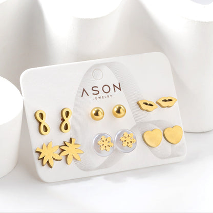 Six pairs of mixed card mounted cut glossy lips / maple leaf stud earrings gold color