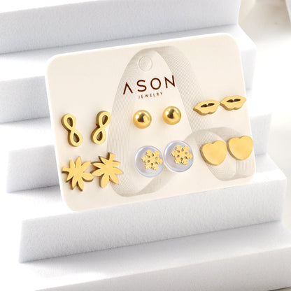 Six pairs of mixed card mounted cut glossy lips / maple leaf stud earrings gold color