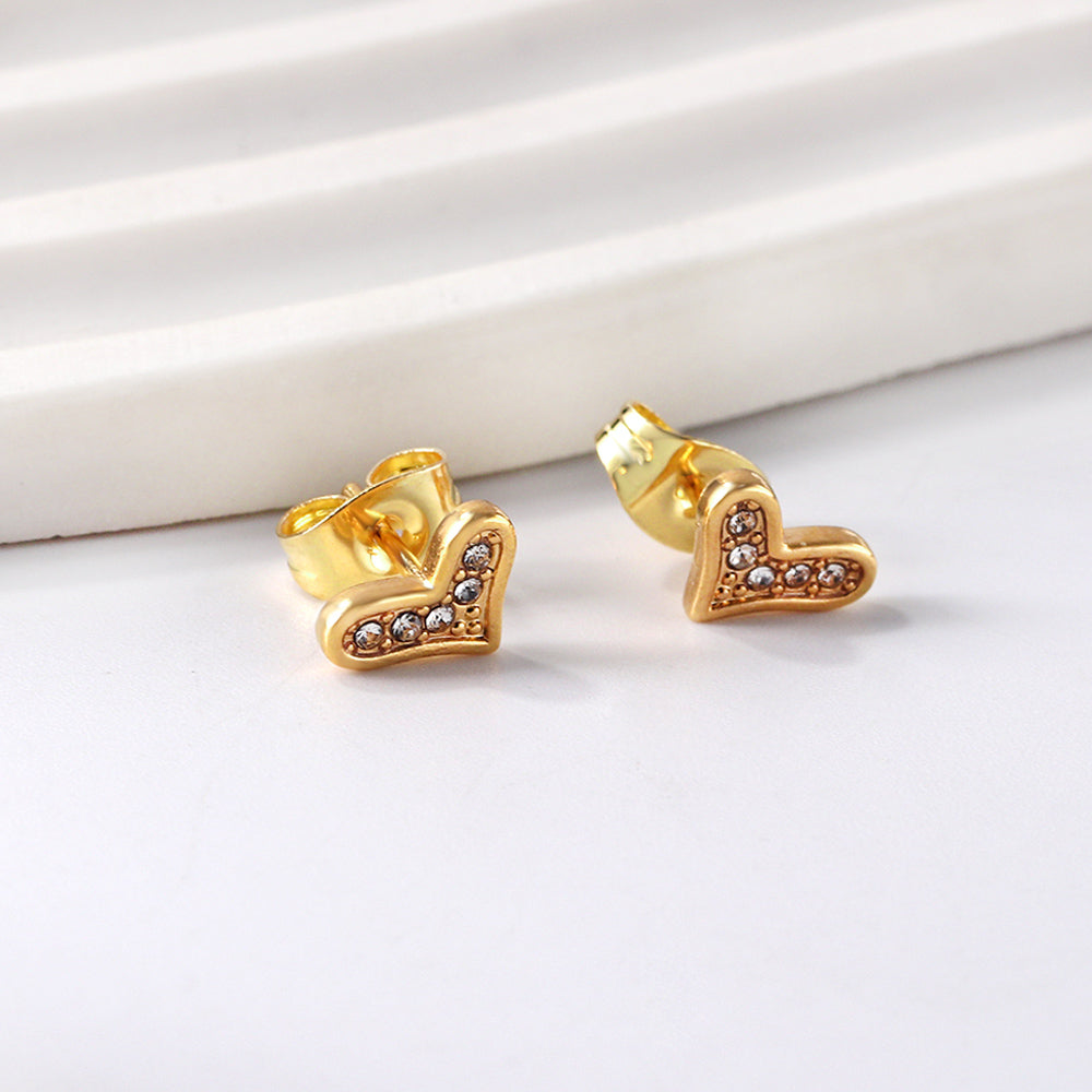 Gold crooked heart cut earrings with diamonds