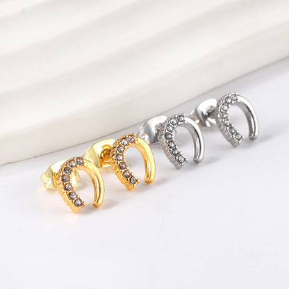 Gold U-shaped cut earrings with diamonds