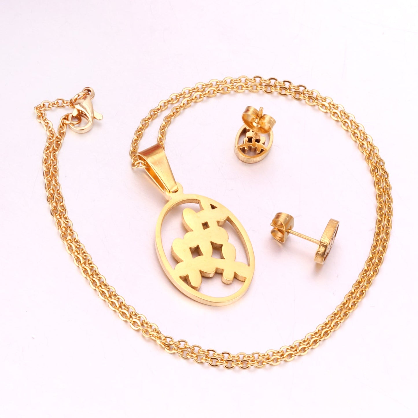 Steel/golden cut jewelry set with grass-like shape in the center without diamonds