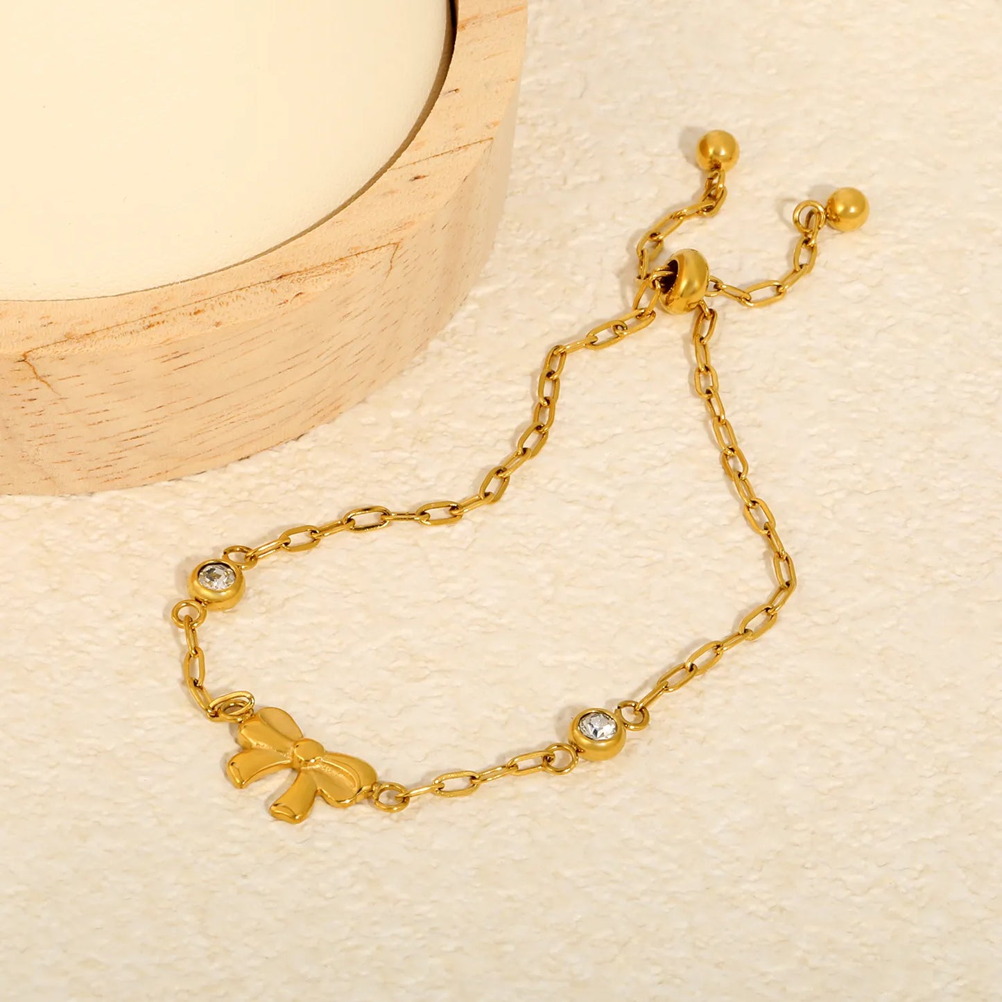 Solid Bow Pendant Two Side Round Zircon Paperclip Chain Slider Adjustable Bracelet | 18K Gold Plated Hypoallergenic Stainless Steel Feminine Wrist Chain Bulk Wholesale