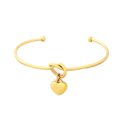 Knot Heart Charm Open Cuff Bangle | 63mm Overall Length | 13.5×11.5mm Knot Detail | 11×12mm Solid Heart Pendant | 18K Gold Plated Stainless Steel Bracelet for Wholesale Supply