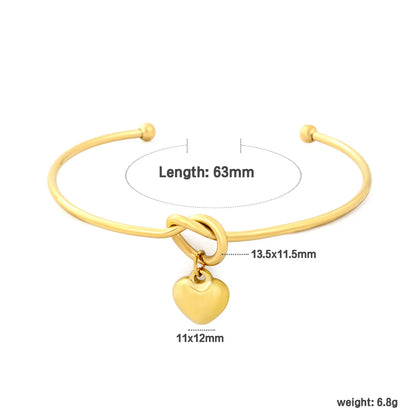 Knot Heart Charm Open Cuff Bangle | 63mm Overall Length | 13.5×11.5mm Knot Detail | 11×12mm Solid Heart Pendant | 18K Gold Plated Stainless Steel Bracelet for Wholesale Supply