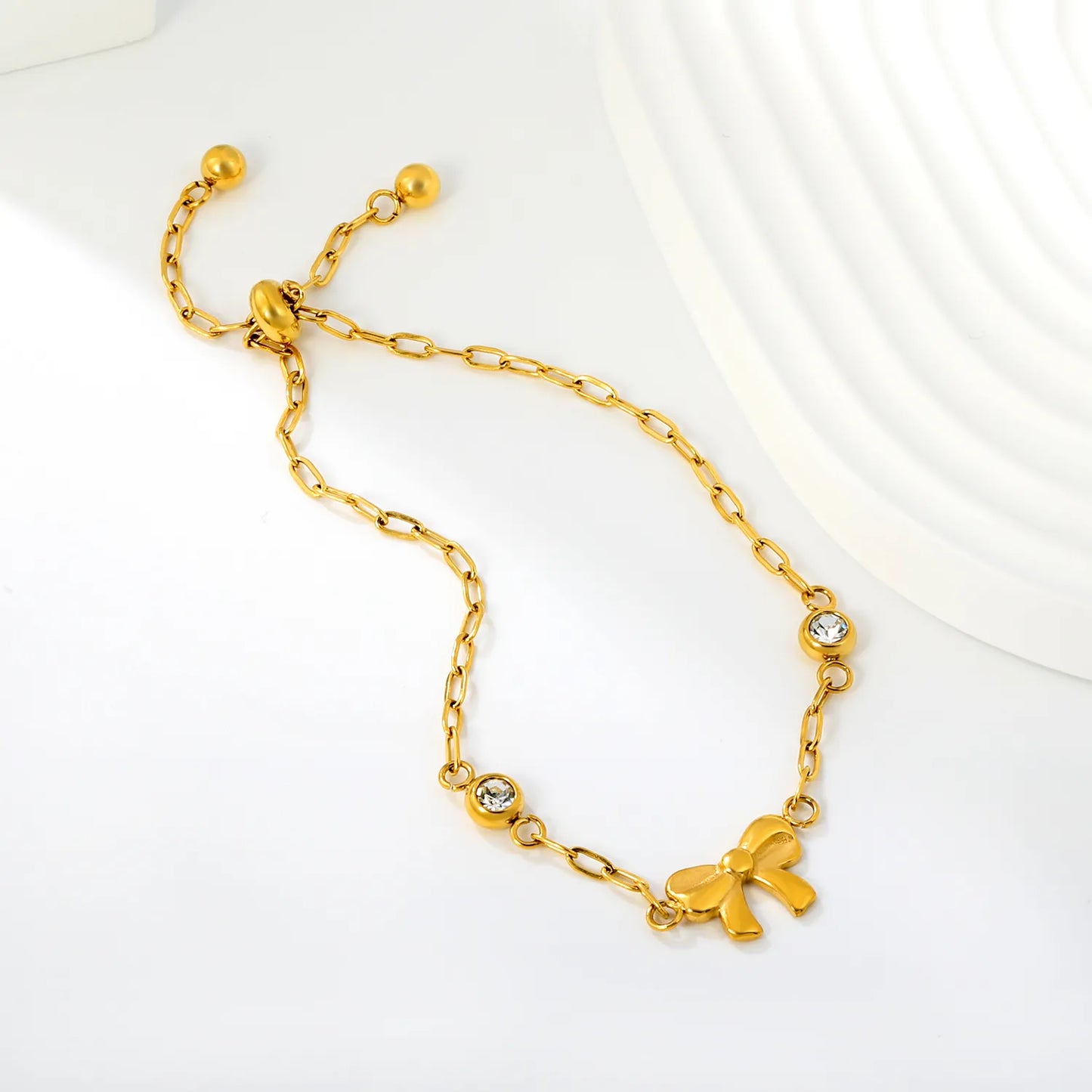 Solid Bow Pendant Two Side Round Zircon Paperclip Chain Slider Adjustable Bracelet | 18K Gold Plated Hypoallergenic Stainless Steel Feminine Wrist Chain Bulk Wholesale