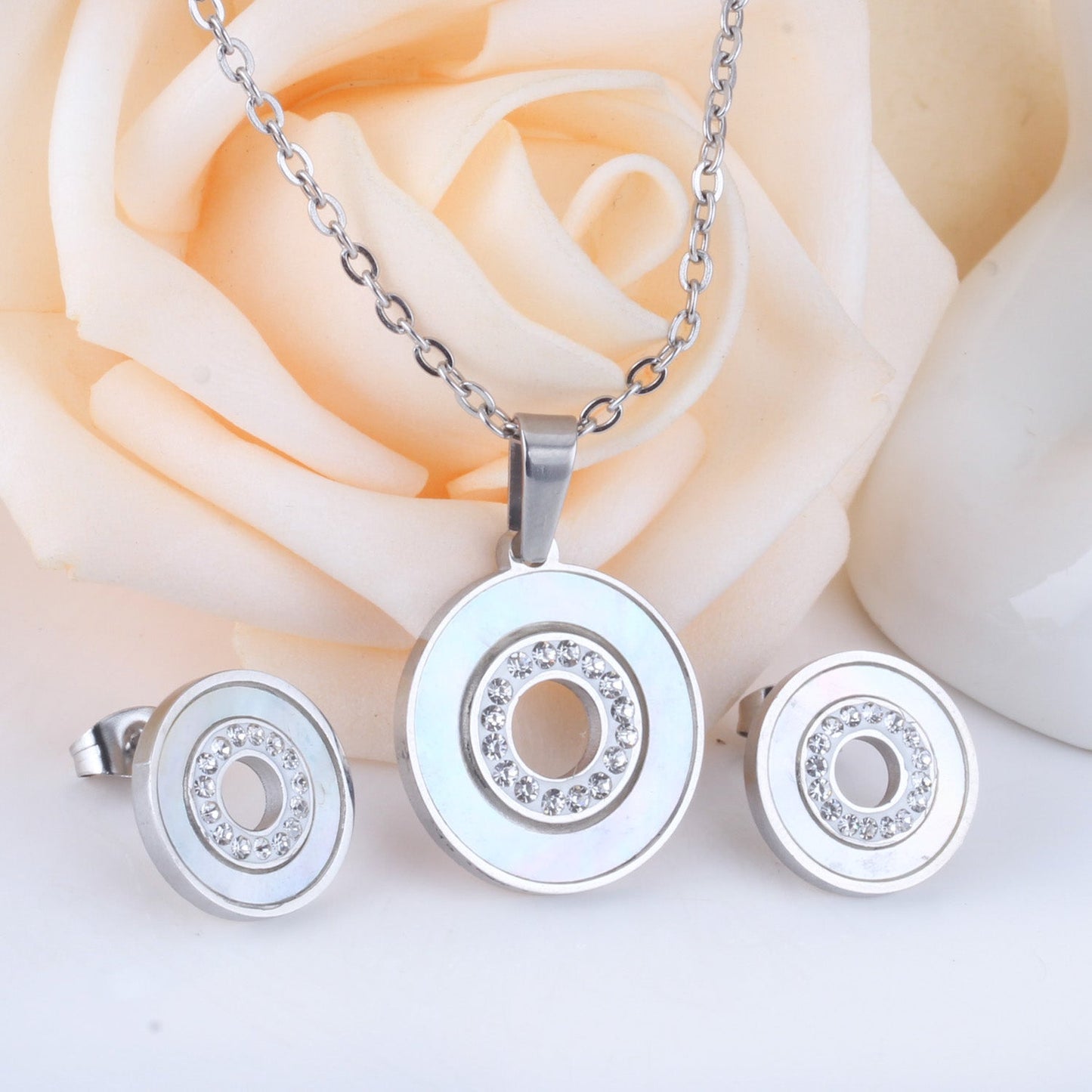 Gold/steel color white shells set with diamonds on top of circle with diamonds jewelry set