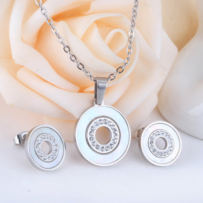 Gold/steel color white shells set with diamonds on top of circle with diamonds jewelry set