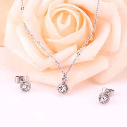 Gold/steel round jewelry set with diamond in the center